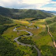 Aerial photo of a winding river in the mountains.