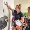 Students from Mark Hernandez’s group at the University of Colorado Boulder install an air quality monitor in a classroom.