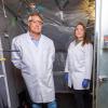 Professor Mark Hernandez and doctoral graduate Marina Nieto-Caballero stand inside the 10-cubic-meters bioaerosol chamber used to study live airborne coronavirus persistence in the Environmental Engineering disinfection laboratory at the Sustainability, Energy and Environment Complex (SEEC).