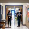  CU Boulder alumna Halle Sago, left, and undergraduate student Ricardo Reyes, right, visit High Peaks Elementary School in Boulder, Colorado, to monitor air quality. (Credit: Glenn Asakawa/CU Boulder)