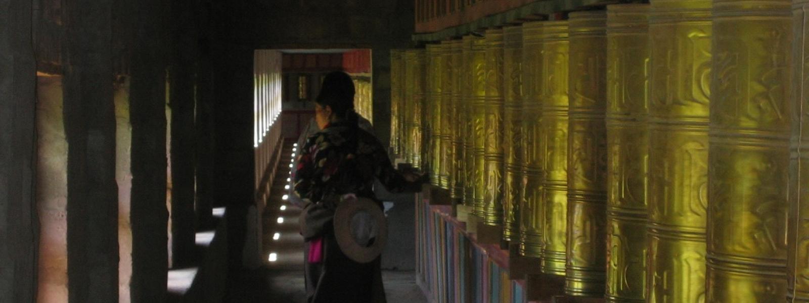 Spinning prayer wheels at Peyul Tharthang