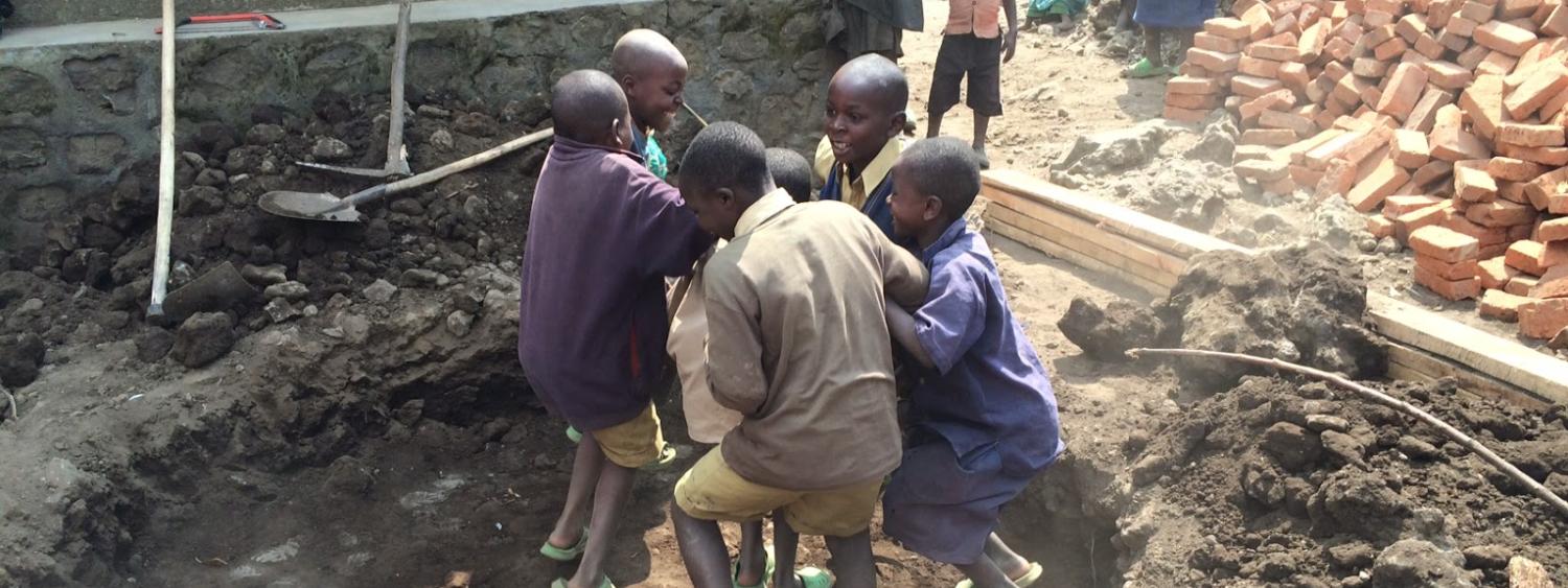 Children helping pack down the dirt