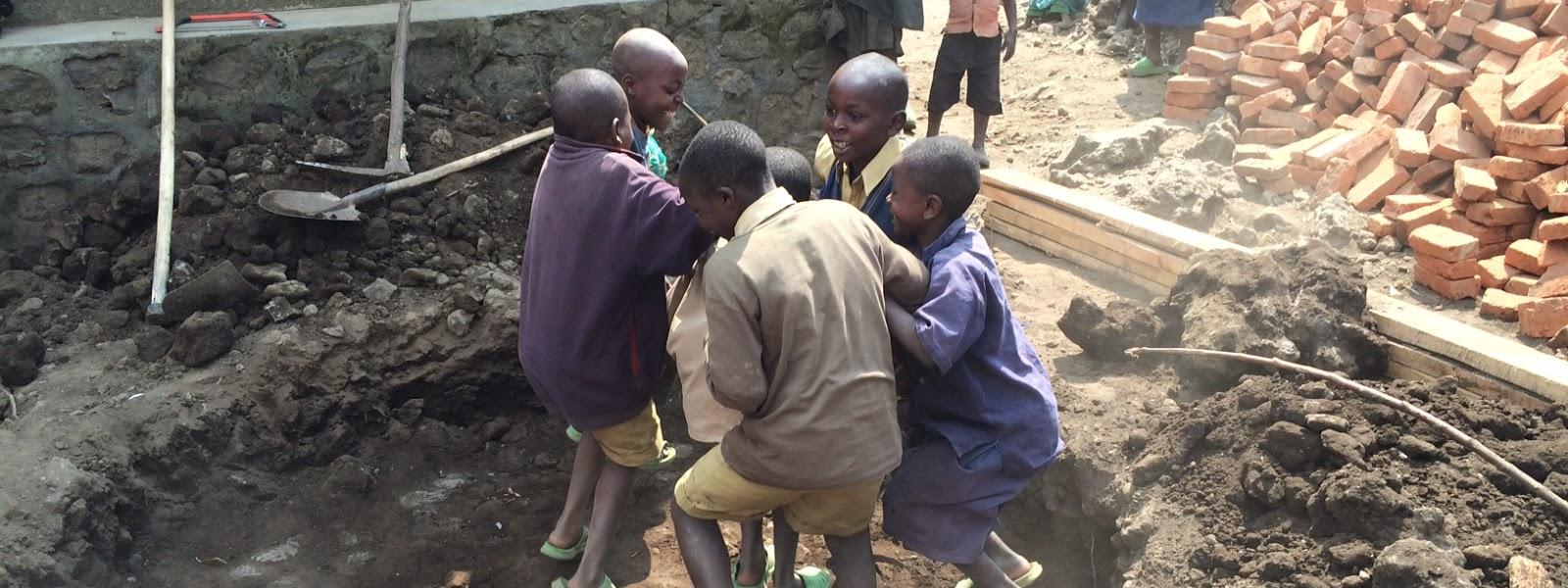 Children helping pack down the dirt