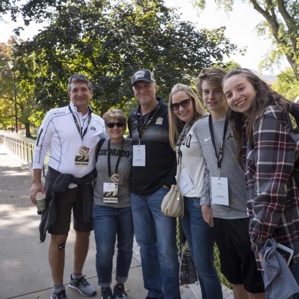 Family poses for photo on campus during annual Family Weekend