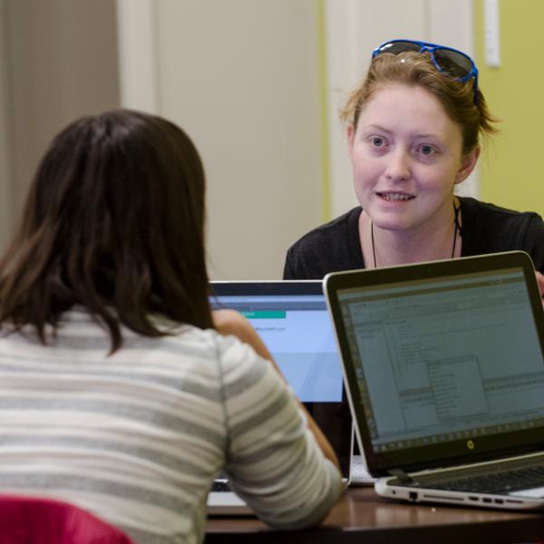 Students on laptops sitting at a table together