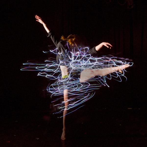 Student performs a modern dance while wearing led-lighted outfits that she designed and constructed herself.