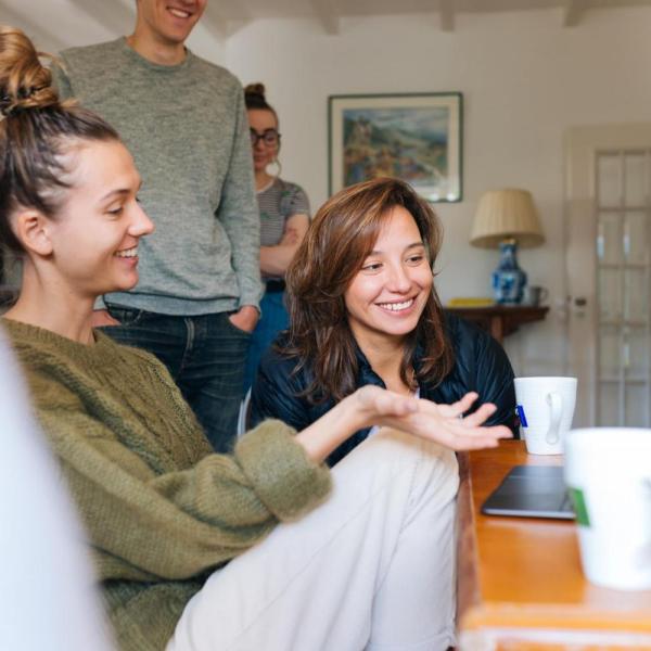 Family gathered around a laptop