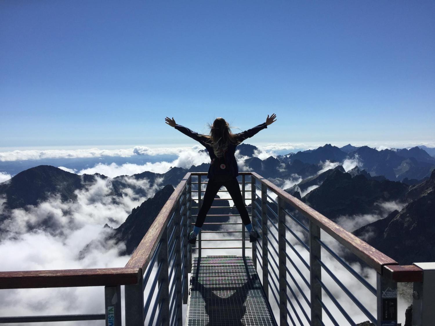 Woman stands on a bridge