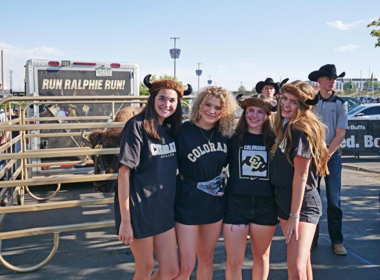 Students in Buffs gear pose for photo with Ralphie at the Rocky Mountain Showdown