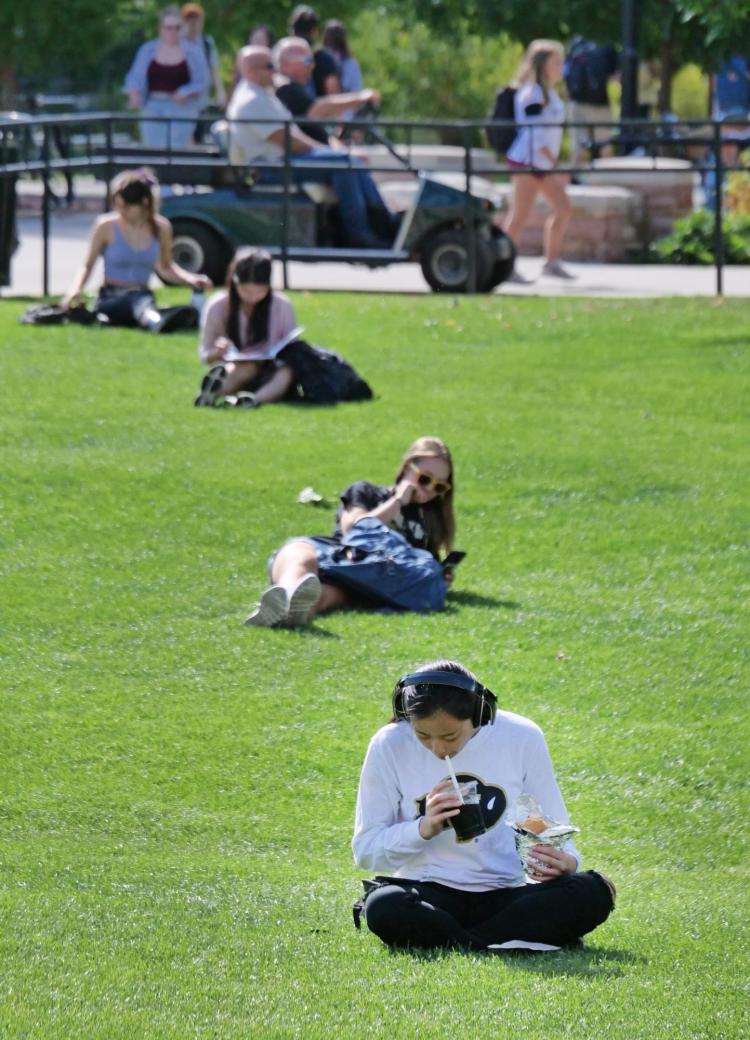 Students relax on the physics lawn between classes