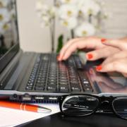 Woman working at a laptop.