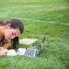 student studying in grass