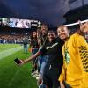 Students pose for photo on sideline of Rocky Mountain Showdown football game