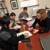 Biochemistry Professor Amy Palmer works with three students in her office