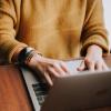 Person writing on laptop
