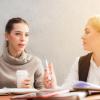 Two women having a conversation over coffee