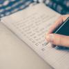 person writing a to-do list