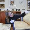 Student looks through old history book with gloves