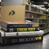stack of textbooks at the CU Book Store