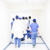 Group of doctors walking down a hospital hallway