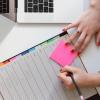 Person writing in colorful planner