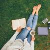 Person reading book and drinking coffee
