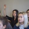 student raises hand in class