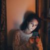A girl looks at her phone
