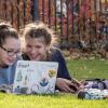 Students working on laptop outside