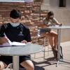 Students studying with masks on.