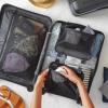 Person packing a suitcase