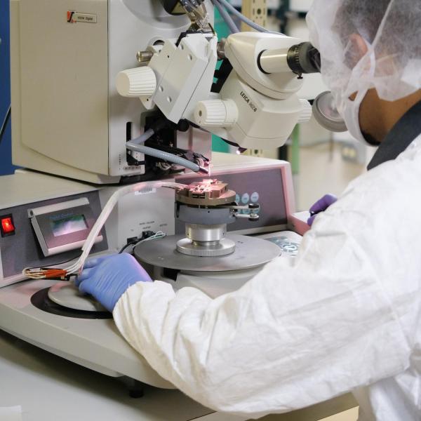 A person looking into a microscope