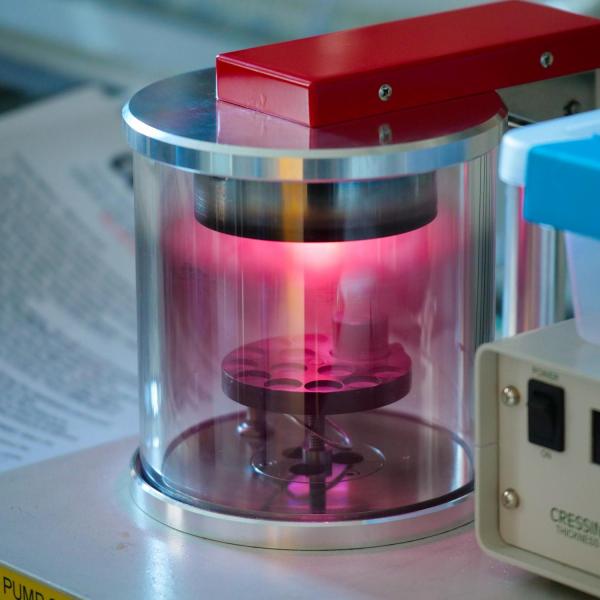 A close up of a piece of lab equipment that is producing a red light