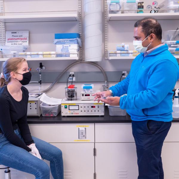 Two people discussing lab equipment