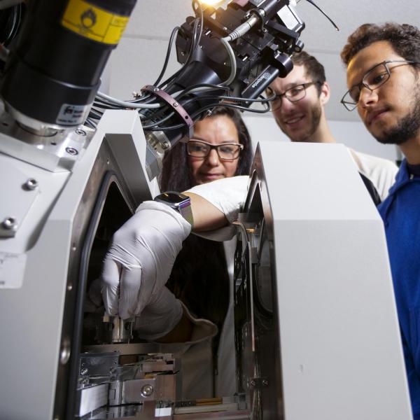 Someone is using the machine as 2 others look on.