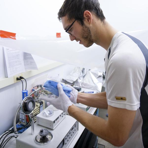 A student is cleaning glass equipment.