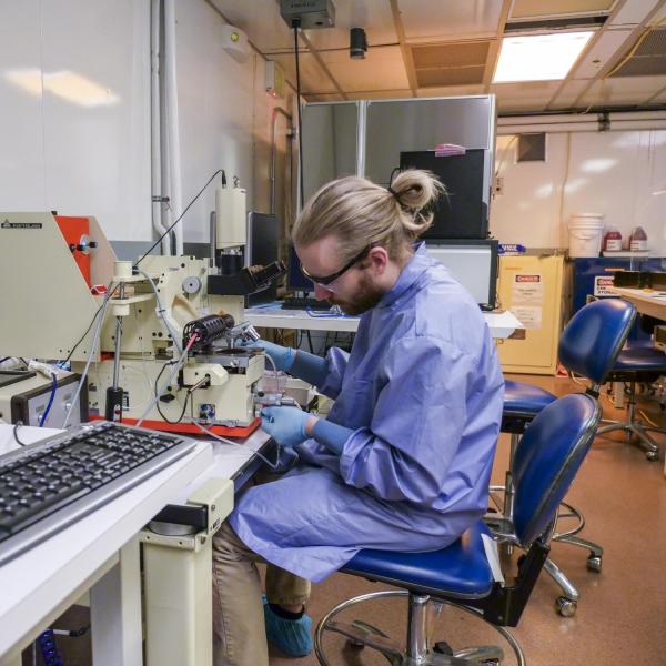 A person is sitting in front of the equipment as they use it.