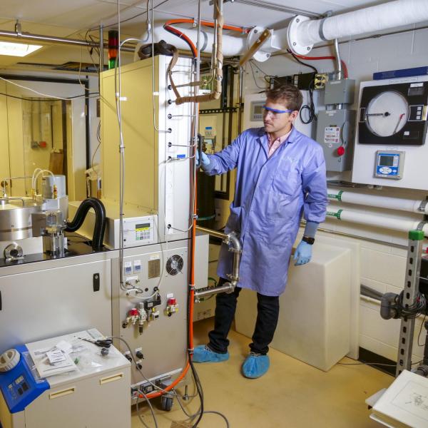 A person interacts with a complicated set of equipment.