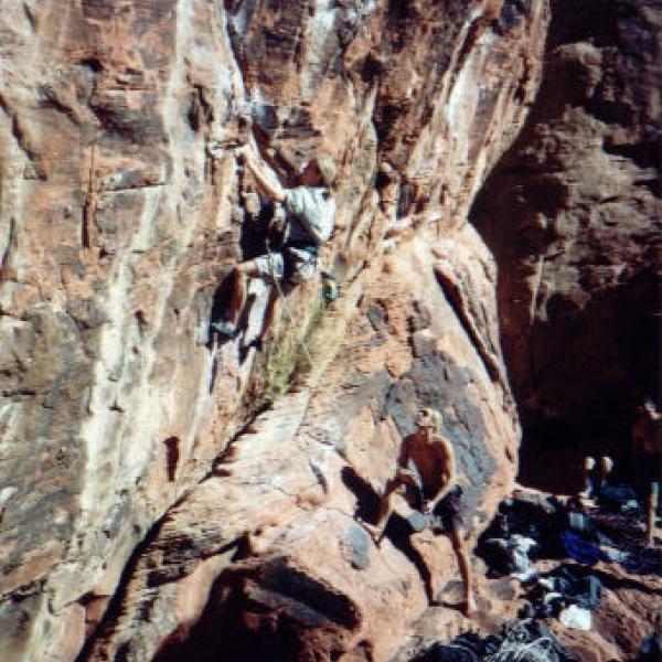 Jesse rockclimbing and Peter Caster belaying