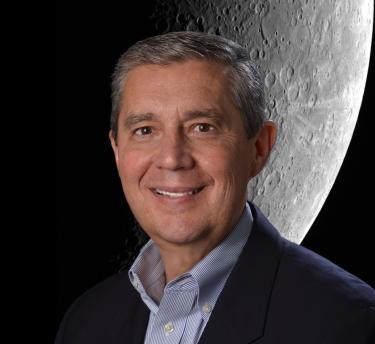 Dr. Jack Burns with Moon image behind him