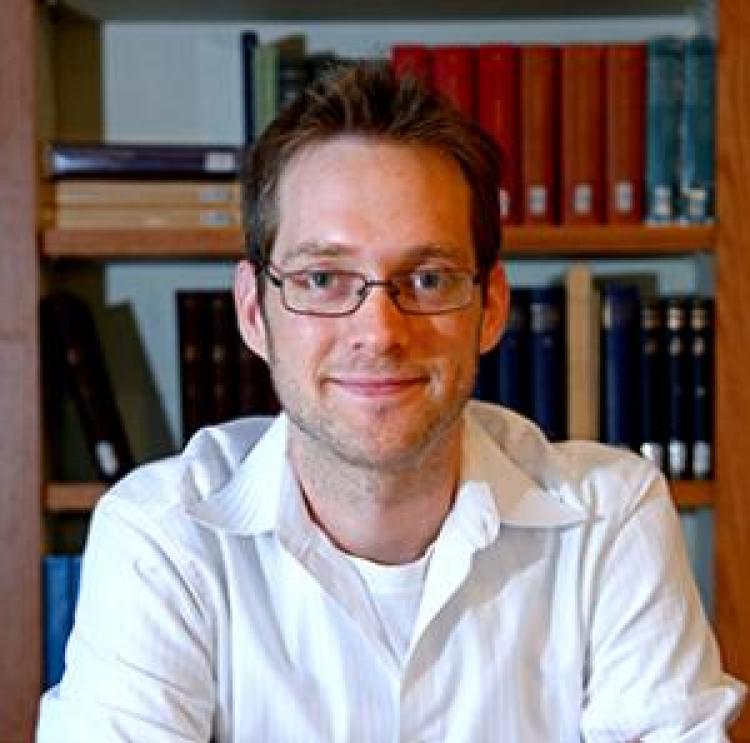 photo of Aaron Clauset, in a library