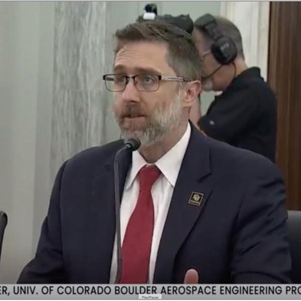 Man speaking into a microphone.