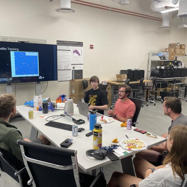 Group of students around a computer.