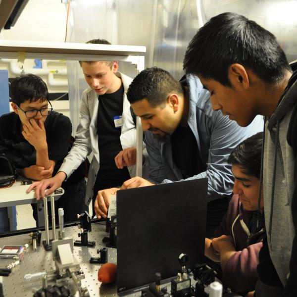 Postdoc Mo Zohrabi showcasing an interferometer.