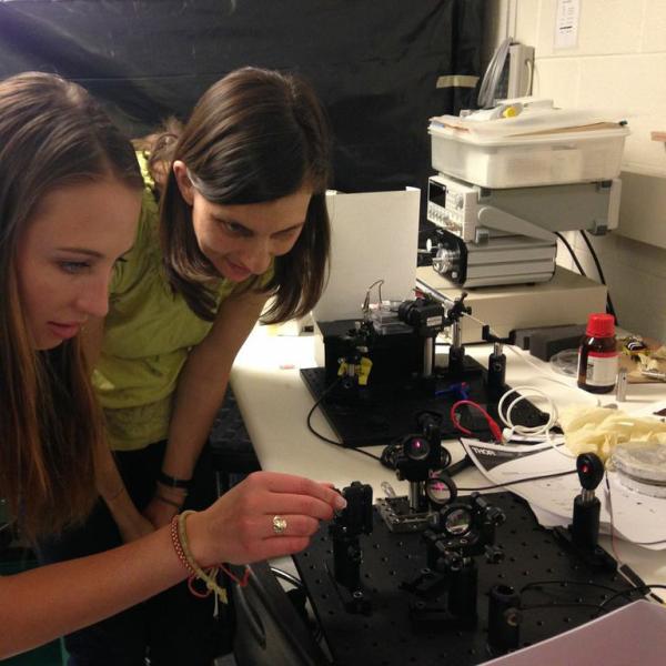 Juliet showing Emma an interferometer.