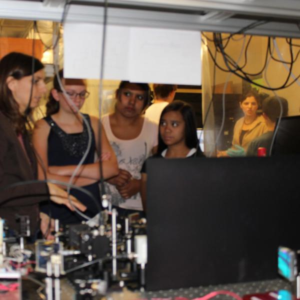 Juliet showing the students a laser setup.