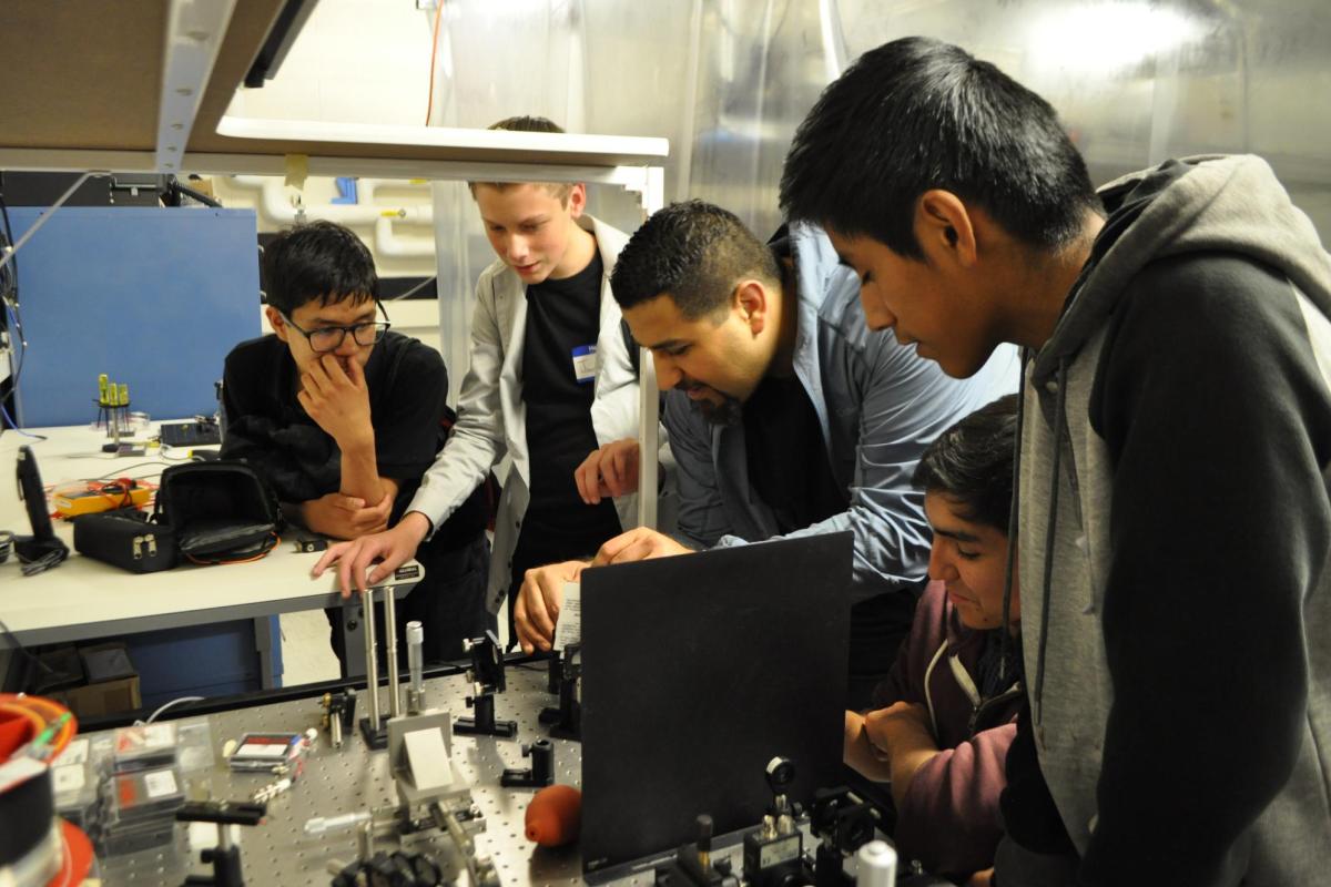 Postdoc Mo Zohrabi showcasing an interferometer.