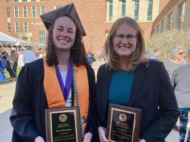 graduate and professor holding awards