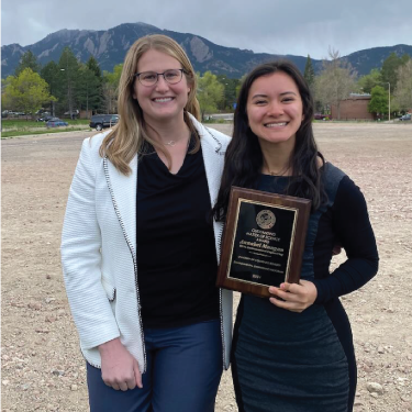 Picture of graduate holding award