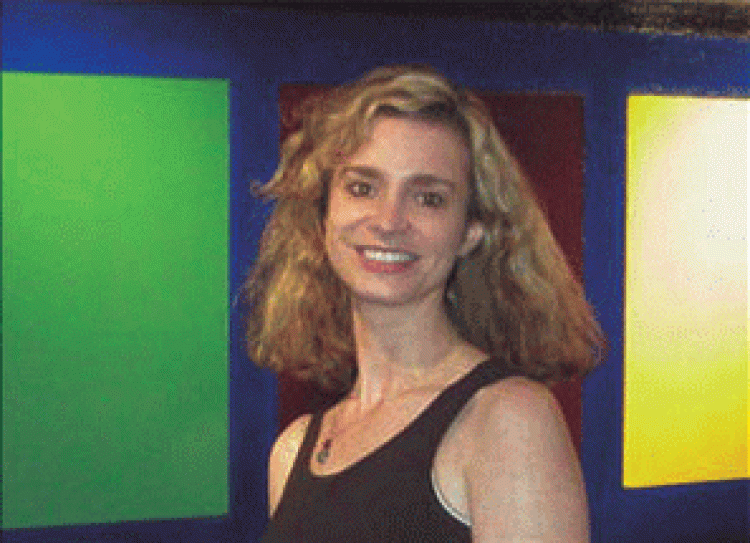 Laura standing in front of her painting